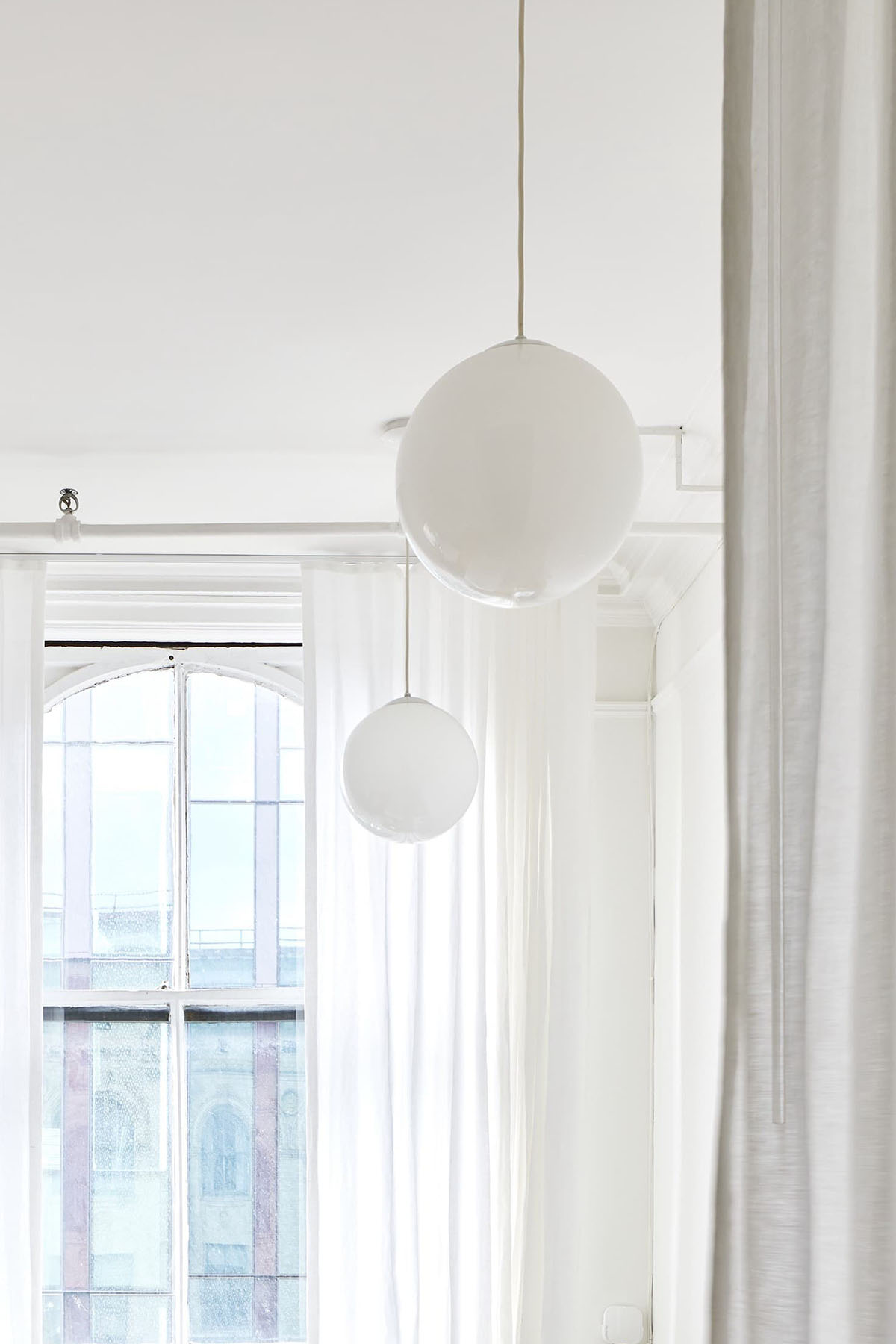 white ceiling with handing white ball lights
